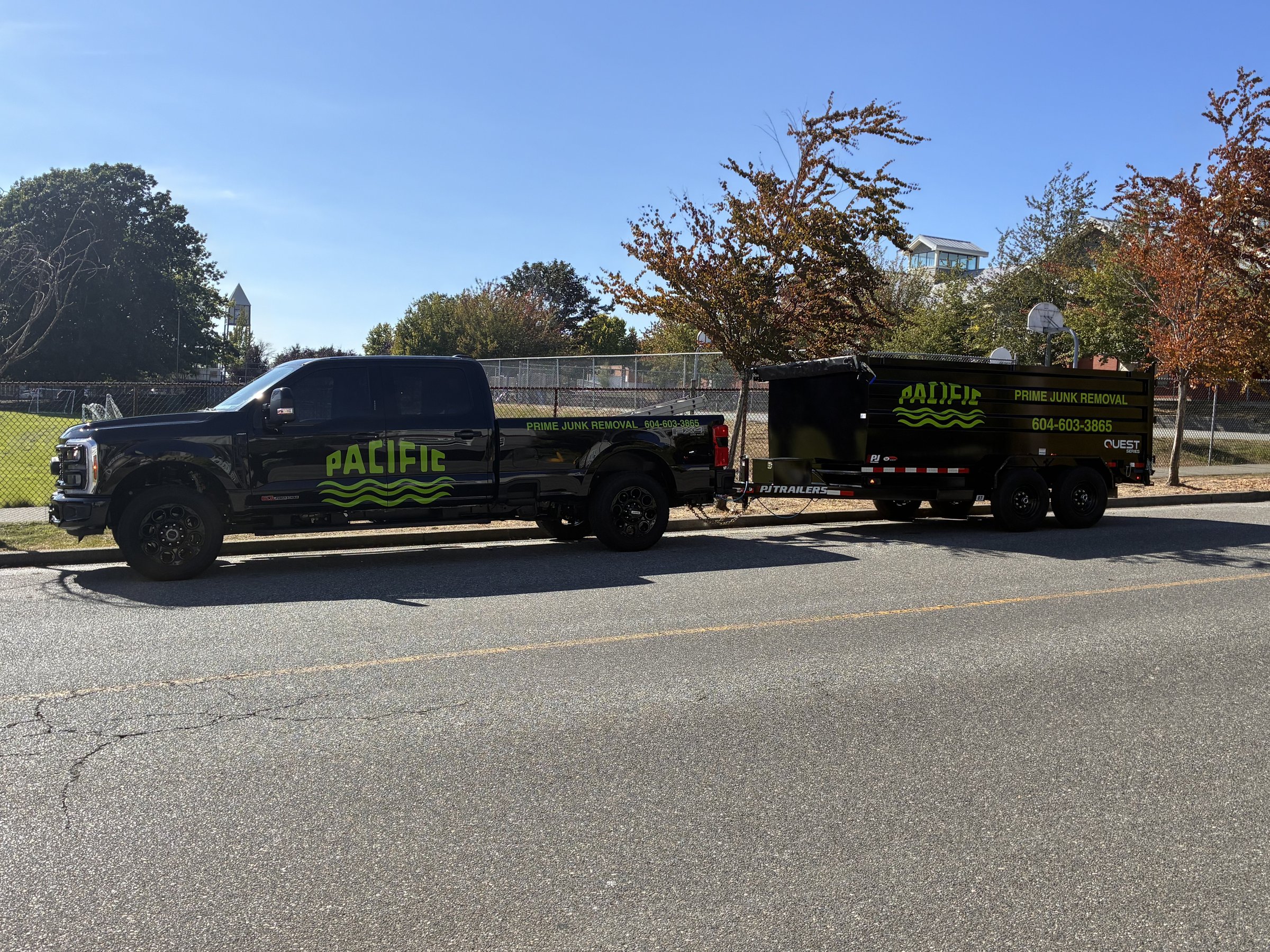 Pacific Prime Junk Removal black truck and neon green dump trailer in White Rock, BC